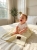Smiling_infant_playing_on_bed_202606111722.jpeg