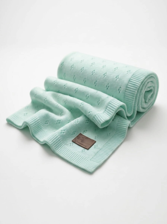 Knitted_baby_blanket_on_white_202606111908.jpeg