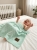 Baby_laughing_on_bed_202606111915 (1).jpeg