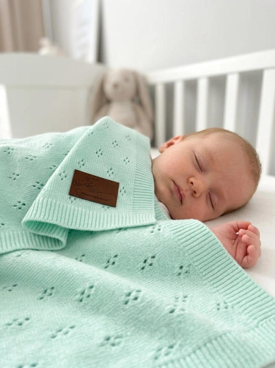 Baby_sleeping_on_mint_blanket_202606111920 (2).jpeg
