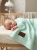 Baby_sleeping_on_mint_blanket_202606111920.jpeg