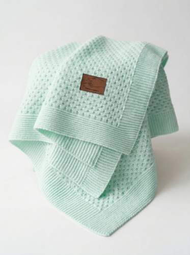 Knitted_baby_blanket_on_white_202606111735.jpeg