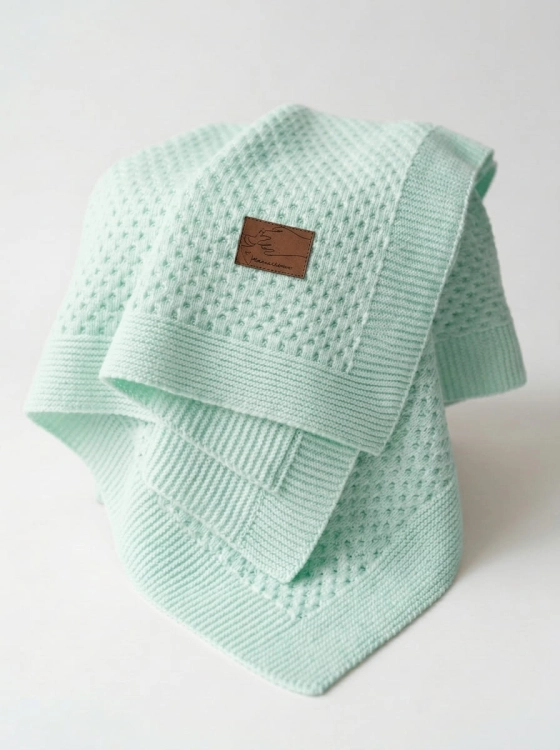 Knitted_baby_blanket_on_white_202606111735.jpeg