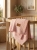 Pink_knitted_blanket_on_crib_202606111751.jpeg